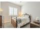 This bedroom offers natural light from the window with wood furnishings and neutral walls at 10246 W Oberlin Way, Peoria, AZ 85383