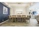 Bright dining area with seating for six, modern lighting, and open access to the kitchen at 10246 W Oberlin Way, Peoria, AZ 85383