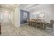 Open dining room with a chandelier and a long wooden table with seating for eight at 10246 W Oberlin Way, Peoria, AZ 85383