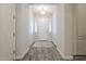 Bright foyer featuring wood-look tile floors, white walls, and a stylish entryway rug at 10246 W Oberlin Way, Peoria, AZ 85383