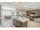 Open floor plan featuring an island kitchen that flows into the dining and living areas at 10246 W Oberlin Way, Peoria, AZ 85383