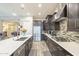 Elegant kitchen with a large island, stainless steel appliances, and a seamless connection to the dining area at 10246 W Oberlin Way, Peoria, AZ 85383