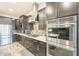 Gourmet kitchen boasts stainless steel appliances, dark wood cabinets, and a stylish backsplash at 10246 W Oberlin Way, Peoria, AZ 85383