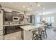 Well-lit kitchen with stainless steel appliances, center island, and dark wood cabinetry, perfect for cooking at 10246 W Oberlin Way, Peoria, AZ 85383
