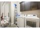 Efficient laundry room featuring modern washer and dryer, and overhead cabinets at 10246 W Oberlin Way, Peoria, AZ 85383