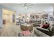 Spacious living room with tile floors, a modern ceiling fan, and open access to the kitchen at 10246 W Oberlin Way, Peoria, AZ 85383
