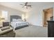 This is a spacious main bedroom featuring a ceiling fan and plantation shutters at 10246 W Oberlin Way, Peoria, AZ 85383