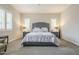 Serene main bedroom features plush bedding, soft lighting, and plantation shutters for optimal comfort at 10246 W Oberlin Way, Peoria, AZ 85383