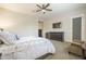 Comfortable main bedroom features a ceiling fan and dresser with flat screen TV at 10246 W Oberlin Way, Peoria, AZ 85383