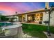 Expansive backyard with a pool, covered patio, manicured lawn, and an outdoor grill, ideal for entertaining at 11336 N 117Th Way, Scottsdale, AZ 85259
