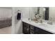 Bathroom with a dual-sink vanity, framed mirror, and modern fixtures at 11336 N 117Th Way, Scottsdale, AZ 85259