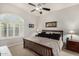 Comfortable bedroom with plantation shutters and neutral tones, creating a serene atmosphere at 11336 N 117Th Way, Scottsdale, AZ 85259