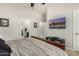 Bedroom with a TV, dark wood furnishings, and an en suite bathroom at 11336 N 117Th Way, Scottsdale, AZ 85259