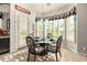Charming breakfast nook with plantation shutters, a glass-top table, and decorative accents at 11336 N 117Th Way, Scottsdale, AZ 85259