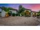 Charming home featuring well-manicured desert landscaping, mature palms, and covered entryway at 11336 N 117Th Way, Scottsdale, AZ 85259