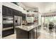Spacious kitchen with granite countertops, stainless steel appliances, and dark wood cabinetry at 11336 N 117Th Way, Scottsdale, AZ 85259