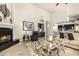 Spacious living room with a fireplace, comfortable seating, and an open floor plan at 11336 N 117Th Way, Scottsdale, AZ 85259