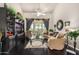 Elegant living room with dark wood floors, a built-in entertainment center, and stylish decor at 11336 N 117Th Way, Scottsdale, AZ 85259