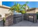 Outdoor kitchen with built-in grill, stainless steel appliances, and granite countertops at 11336 N 117Th Way, Scottsdale, AZ 85259