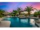 Beautiful pool featuring rock features, mature landscaping, and covered BBQ area perfect for entertaining at 11336 N 117Th Way, Scottsdale, AZ 85259