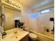 Bright bathroom with a shower-tub combo, modern fixtures, and a decorative plant at 12046 W Scotts Dr, El Mirage, AZ 85335