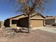 Charming single-story home with a well-maintained front yard and a two-car garage at 12046 W Scotts Dr, El Mirage, AZ 85335