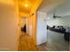Inviting hallway leading to a living area with neutral walls and updated wood-look flooring at 12046 W Scotts Dr, El Mirage, AZ 85335