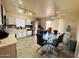 Bright and airy eat-in kitchen with white cabinets, granite countertops and wood-look flooring at 12046 W Scotts Dr, El Mirage, AZ 85335