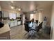 Bright and airy eat-in kitchen with white cabinets, granite countertops and wood-look flooring at 12046 W Scotts Dr, El Mirage, AZ 85335