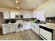 Bright kitchen features white cabinets, a mosaic tile backsplash and stainless steel appliances at 12046 W Scotts Dr, El Mirage, AZ 85335
