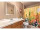 Charming bathroom features a decorative mirror and vanity, complemented by a colorful cactus shower curtain at 12050 N Panorama Dr # 104, Fountain Hills, AZ 85268