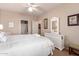 Comfortable bedroom with a queen bed, white furniture, and a ceiling fan at 12050 N Panorama Dr # 104, Fountain Hills, AZ 85268