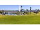 Expansive green lawn and walking path overlooking the community lake with fountain and mountain views at 12050 N Panorama Dr # 104, Fountain Hills, AZ 85268