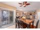 Inviting dining area with wood table, tile flooring, and a view extending to the living area and sliding glass door at 12050 N Panorama Dr # 104, Fountain Hills, AZ 85268