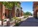 Beautifully landscaped property with lush greenery and a sidewalk lined with palm trees on a clear day at 12050 N Panorama Dr # 104, Fountain Hills, AZ 85268