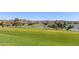Expansive community green space with lush lawn and mature trees overlooking the tranquil lake and nearby residences at 12050 N Panorama Dr # 104, Fountain Hills, AZ 85268