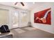 Spacious home gym with neutral walls, ceiling fan, and door to the patio at 12050 N Panorama Dr # 104, Fountain Hills, AZ 85268