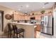 Modern kitchen with stainless steel appliances, light wood cabinetry and bar seating for casual dining at 12050 N Panorama Dr # 104, Fountain Hills, AZ 85268