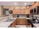 Functional kitchen features stainless steel appliances, ample cabinet space, and stylish backsplash at 12050 N Panorama Dr # 104, Fountain Hills, AZ 85268