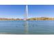 Scenic view of a lake featuring a fountain, lush greenery, and clear blue skies at 12050 N Panorama Dr # 104, Fountain Hills, AZ 85268
