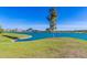 Scenic lake view with green lawn, disc golf, and lush landscaping under a clear blue sky at 12050 N Panorama Dr # 104, Fountain Hills, AZ 85268