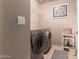 Efficient laundry room with washer, dryer, storage shelf and decorative accents at 12050 N Panorama Dr # 104, Fountain Hills, AZ 85268
