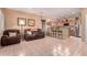 Inviting living room with tile flooring, a comfortable recliner and sofa, and an open view into the kitchen at 12050 N Panorama Dr # 104, Fountain Hills, AZ 85268