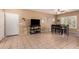 Bright living room featuring tile floors, natural light, a dining area, and a television on a console at 12050 N Panorama Dr # 104, Fountain Hills, AZ 85268