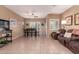 Comfortable living room with tile flooring, a dining area and an inviting, reclining sofa at 12050 N Panorama Dr # 104, Fountain Hills, AZ 85268