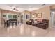 Bright living room featuring tile floors, a ceiling fan, dining area, and inviting brown reclining sofa at 12050 N Panorama Dr # 104, Fountain Hills, AZ 85268