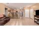 Open-concept living room with tile floors, kitchen bar, stainless steel appliances and television at 12050 N Panorama Dr # 104, Fountain Hills, AZ 85268