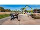 Park entrance featuring a statue, sidewalk, and landscaping, with play equipment under a colorful shade at 12050 N Panorama Dr # 104, Fountain Hills, AZ 85268