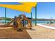 Neighborhood playground featuring shade canopies, climbing wall, slides, and lake views at 12050 N Panorama Dr # 104, Fountain Hills, AZ 85268