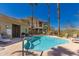 Inviting community pool with tall palm trees, lounge chairs, and crystal clear water under a bright blue sky at 12050 N Panorama Dr # 104, Fountain Hills, AZ 85268